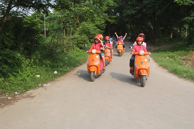 Hanoi Vespa Full Day City & Countryside with Female Ao Dai Riders - West Lake and Huu Hiep Lake: gardens, narrow alleys, and the B52 site