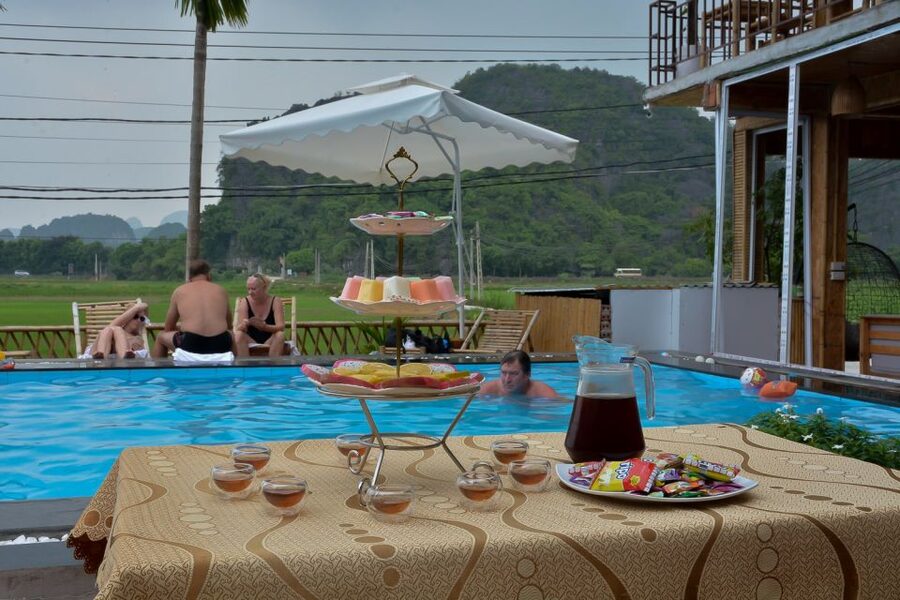 Ninh Binh Daily: Hoa Lu, Mua Cave, Tam Coc, Bike & Swimming - Lunch at the pool bungalow, then tea, fruit, and swimming at sunset