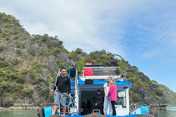 One Day Lan Ha Bay with Cat Ba Expedition Tour - Bãi tắm Vạn Bội beach: clear water and a mountain horizon